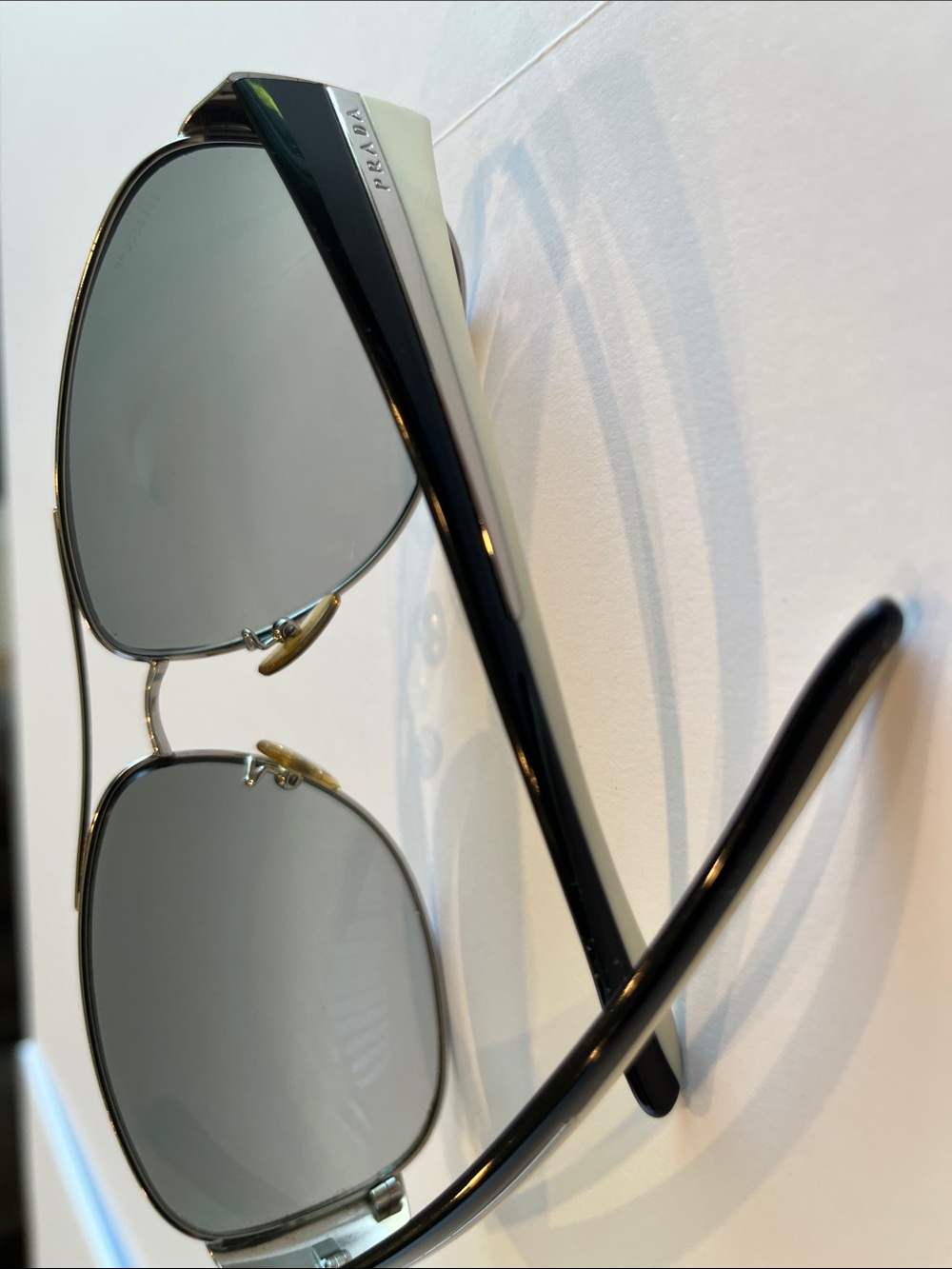 Prada Aviator Sunglasses with Black and Cream temples.